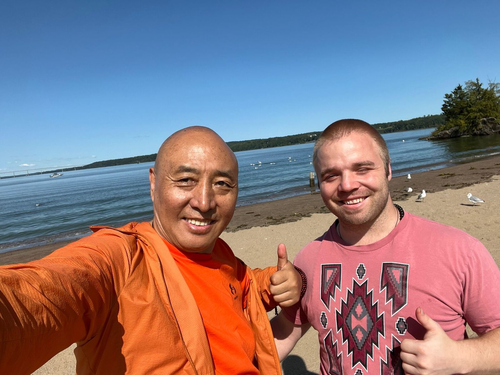 Davis Trachte and his teacher smiling on a lakeshore