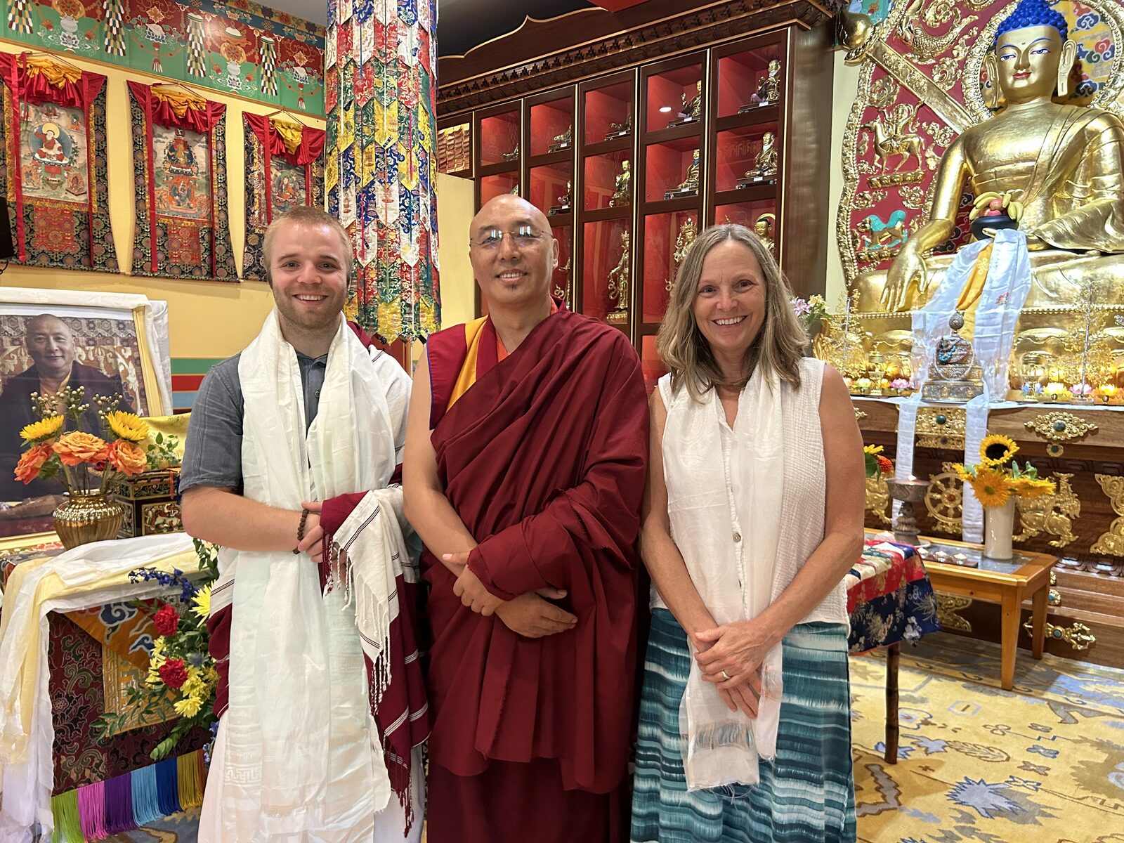 Davis and his teacher receiving a ceremonial khata scarf in a shrine room